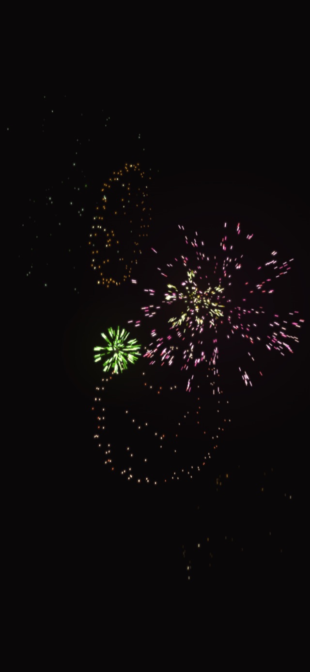 iPhone에서 본 Fireworks 테마 — 검은 화면에 분홍, 연두, 주황 불꽃